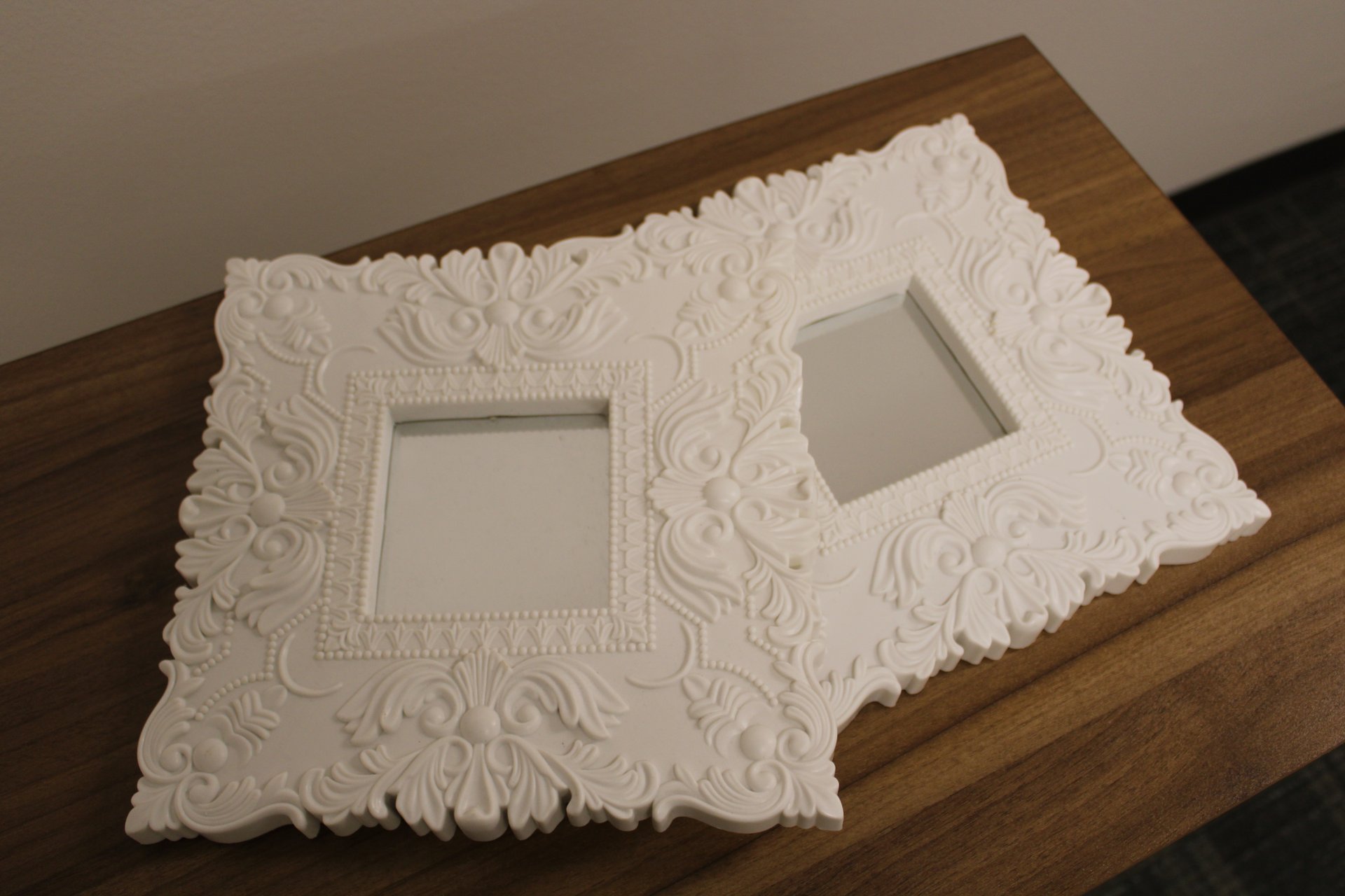 Two matching white diamond mirror art